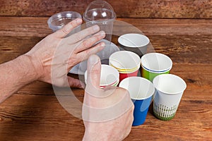 Gestures approving use disposable paper cups and renounce plastic tableware