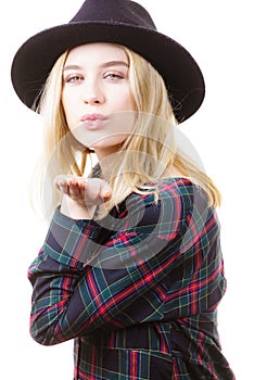 Woman in hat sending air kiss