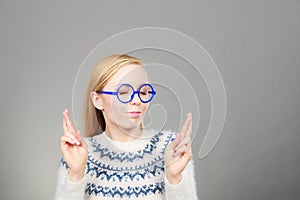 Teenage blonde woman making promise gesture