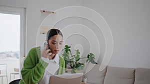 Gesturing businesswoman calling phone walking at room. Woman talking telephone