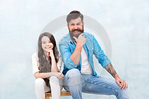 Get the best friend. Happy daughter and father sit on stool. Father child relations. Bearded man and small girl enjoy
