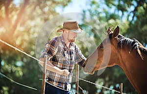 Get closer to nature. a farmer standing with his horse.