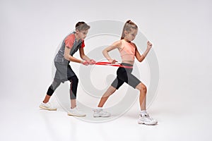 Get fit together. Full-length shot of teenage boy and girl engaged in sport, looking focused while exercising with