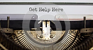 Get help here, support symbol. Concept words `Get help here` typed on retro typewriter. Business, get help here, support concept