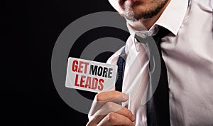 Get more leads card in male hands on black