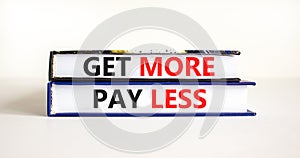 Get more pay less symbol. Concept words Get more pay less on books on a beautiful white table white background. Business Get more