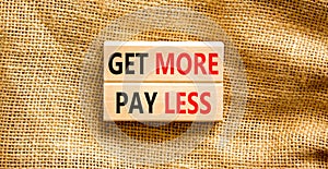 Get more pay less symbol. Concept words Get more pay less on wooden blocks on a beautiful canvas table canvas background.