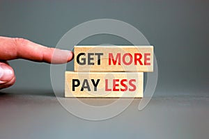 Get more pay less symbol. Concept words Get more pay less on wooden blocks on a beautiful grey table grey background. Businessman