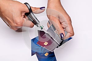 Get out of credit card debt. Woman is cutting bank card
