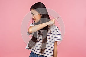 Get out, leave me! Portrait of irritated dissatisfied brunette girl in striped t-shirt showing way out, ordering to go away