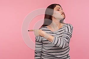 Get out! Portrait of vexed angry woman in striped sweatshirt grimacing madly and ordering to go away