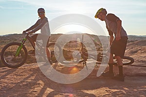 Get out there and ride. Full length shot of two young male athletes mountain biking in the wilderness.