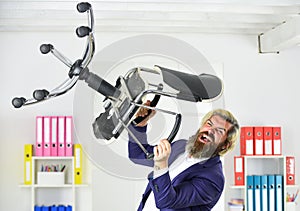 Get rid of the excess. Businessman standing in office hold chair. Stress concept. Crazy or mad. Business man aggressive