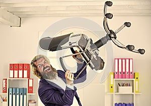 Get rid of the excess. Businessman standing in office hold chair. Stress concept. Crazy or mad. Business man aggressive