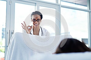 Get screen and stop health scares before they start. a young gynaecologist giving an okay sign during a consultation photo