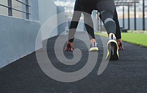 Get set and ready to go. Closeup shot of a sporty man in starting position while exercising outdoors.