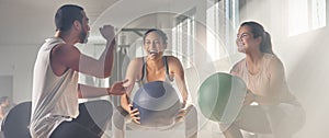 Get some assistance, itll be fun. two women using fitness balls while working out with their trainer.