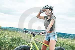 Get tired of mountain biking - woman with fatbike and protection photo