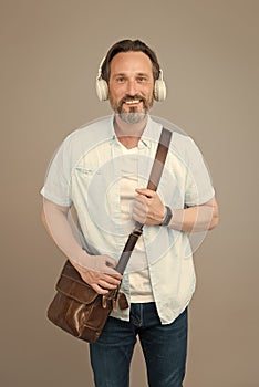 Get the very best audio experience. Bearded man listen to music grey background. Mature male wear audio headphones. Hi