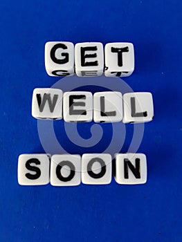 Get well soon words letters on white blocks on a blue background