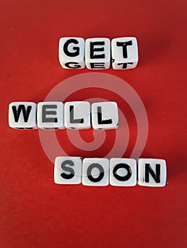 Get well soon words letters on white blocks on a red background