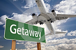 Getaway Green Road Sign and Airplane Above