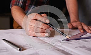 Getting the angle just right. An architect drawing up plans for a house.