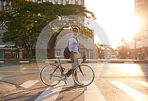 Getting around the city on his two wheels. a businessman commuting to work with his bicycle.