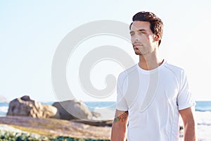 Getting back to nature. a young man enjoying a day at the ocean.