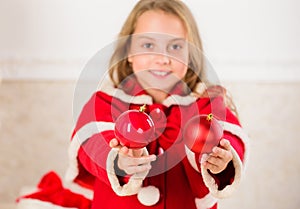 Getting child involved decorating. How to decorate christmas tree with kid. Girl smiling face hold balls ornaments white