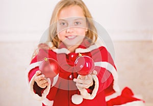 Getting child involved decorating. How to decorate christmas tree with kid. Girl smiling face hold balls ornaments white