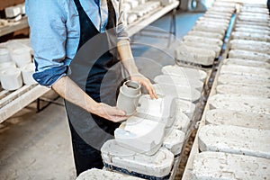 Getting clay products from the forms at the manufacturing