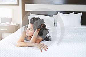 Getting comfortable. a young woman wearing lingerie in her bedroom.