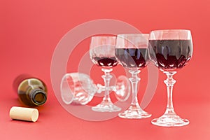 Getting drunk from red wine in elegant crystal glasses