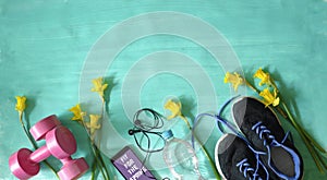 Getting fit,reducing weight and workout in the springtime,flat lay with fitness items and daffodil flowers