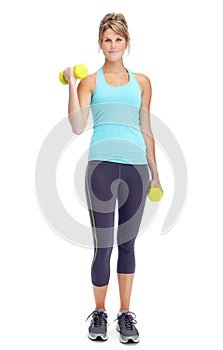 Getting a great workout. Attractive young woman in sportswear lifting dumbbells while isolated on white.