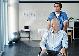 Getting his health back on track. a male nurse caring for a senior patient in a wheelchair.