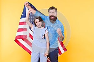 Getting in the holiday spirit. Father and small child holding american flag on national holiday. Happy family