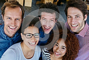 Getting the job done with a smile. Closeup portrait of a group of estatic coworkers standing in an office.