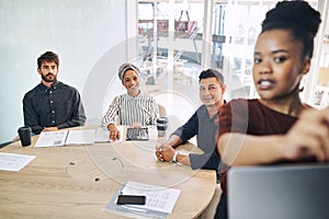 Getting the lowdown on the latest in business. a group of businesspeople listening to a presentation from a colleague in