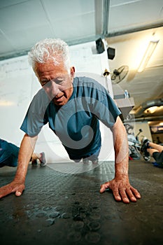 Getting older, getting fitter. a senior man working out in the gym.