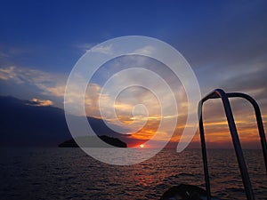 Getting ready for an adventure of night dive with beautiful sunset view on surface.