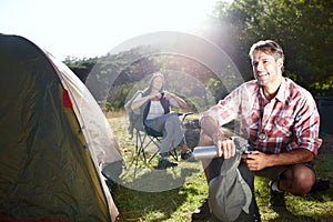 Getting ready for the big hike. Portrait of a young couple planning for their hike.