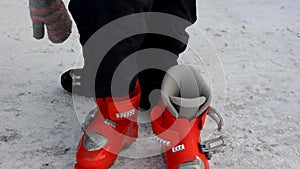 Getting ready for skiing - fastening the boots. boy wear ski boots. Winter sport. outdoor.