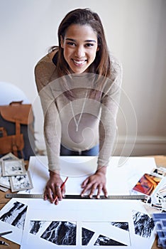 Getting ready to showcase her portfolio. A young woman working on her portfolio at home.