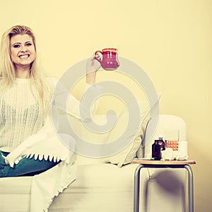 Happy woman showing cup of tea