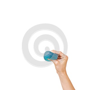 Getting rid of stress. Cropped view of a womans hand squeezing a stress ball against a white background.