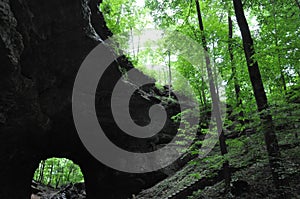 Hiking a wooded trail in Kentucky leading to a cave.