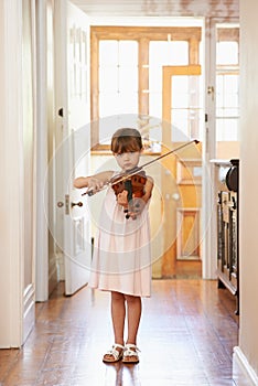 Getting in some violin practive. Shot of a young girl playing violin.