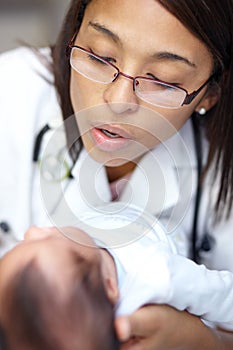 Getting a thorough checkup. A young female doctor examining an infant who has a cleft palate.